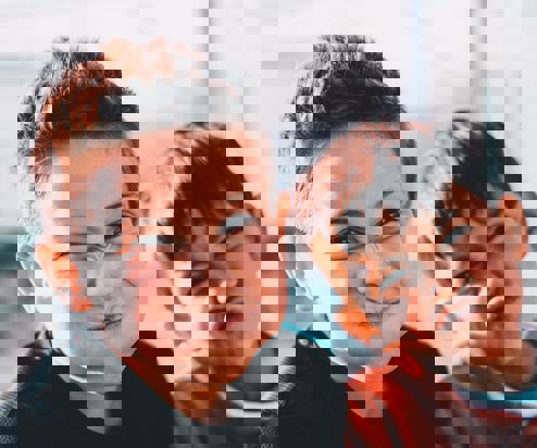 Two young boys pulling silly faces at the camera