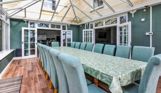 Internal of a manor house conservatory dining area with table and chairs for 18 guests