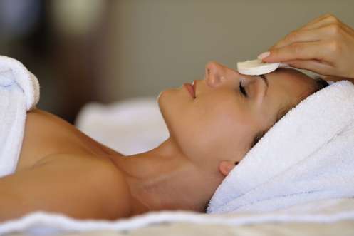 A lady laid down having a facial treatment