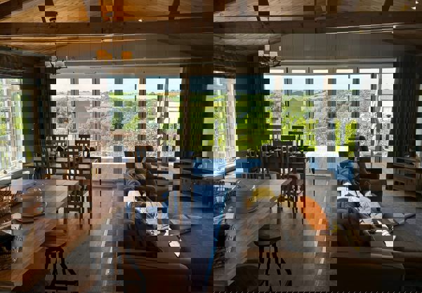 View outside to valley beyond from the living area showing open plan layout in modern country style