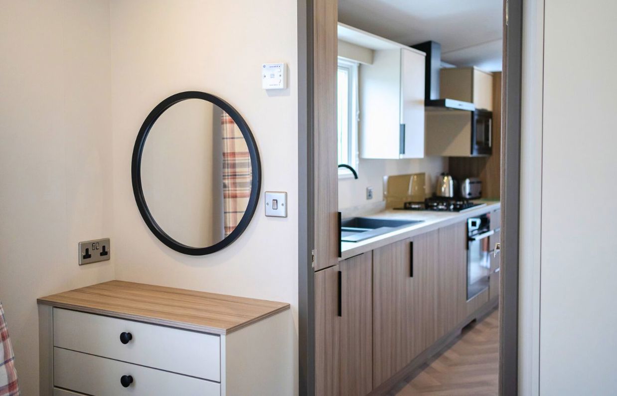 Internal of a caravan open plan kitchen adjacent to bedroom