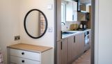 Internal of a caravan open plan kitchen adjacent to bedroom