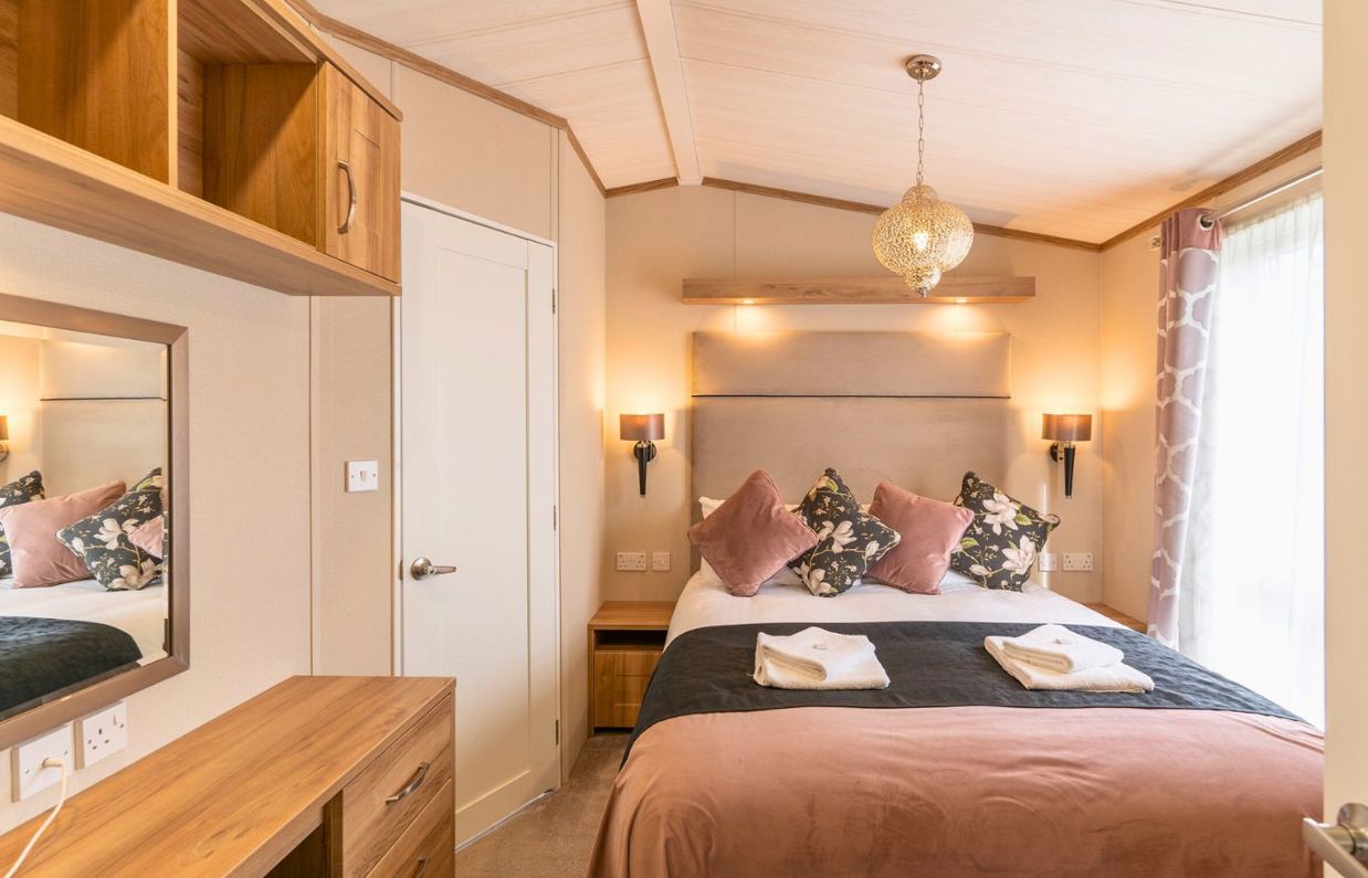 Internal of a caravan master bedroom with dressing area