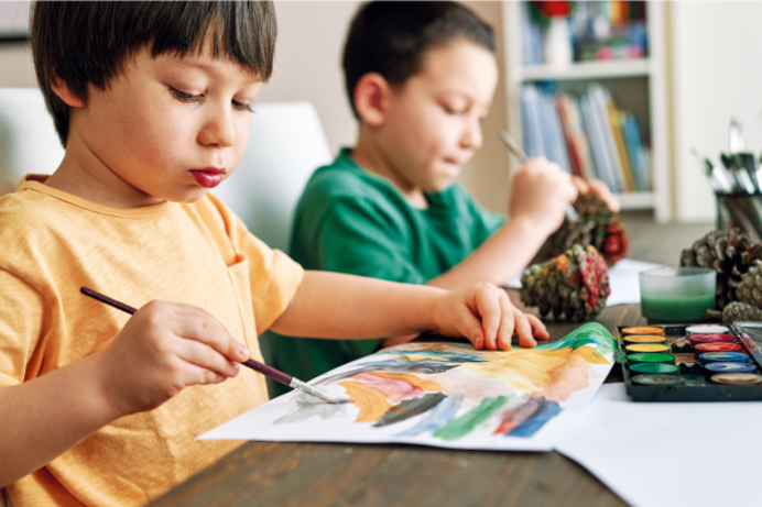 Two young children painting