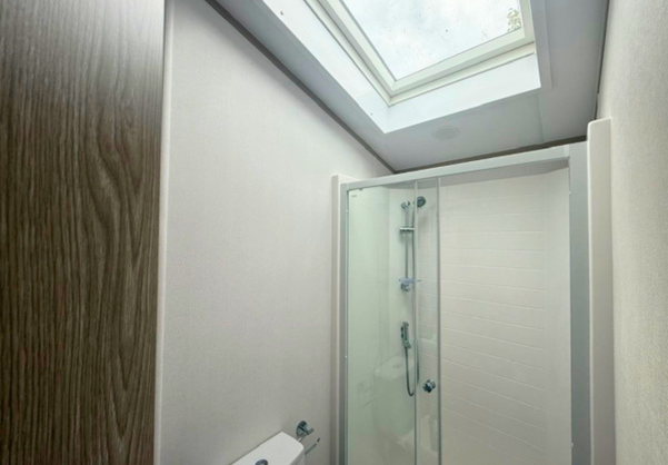 Internal of a caravan bathroom with shower and velux sky light