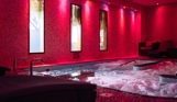A hydrotherapy pool with loungers and calm lights