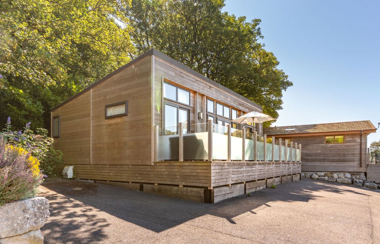 External of a lodge with decking and outdoor furniture