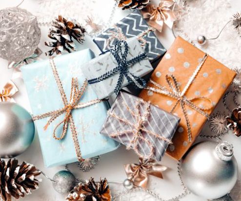 A variation of christmas gifts surrounded by coastal inspired christmas decorations taken from above
