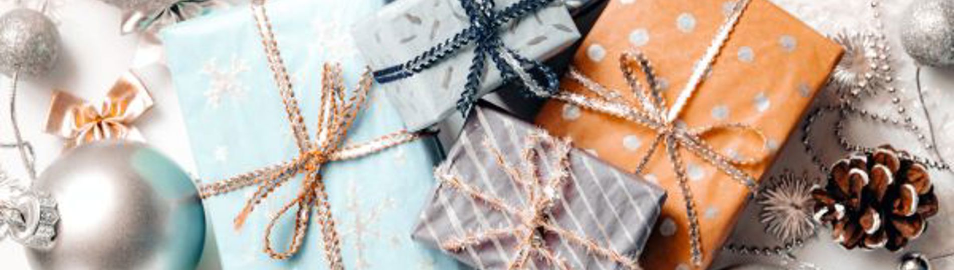 A variation of christmas gifts surrounded by coastal inspired christmas decorations taken from above