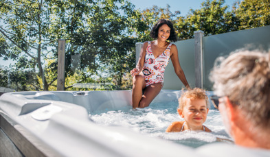Family in hot tub surrounded by trees