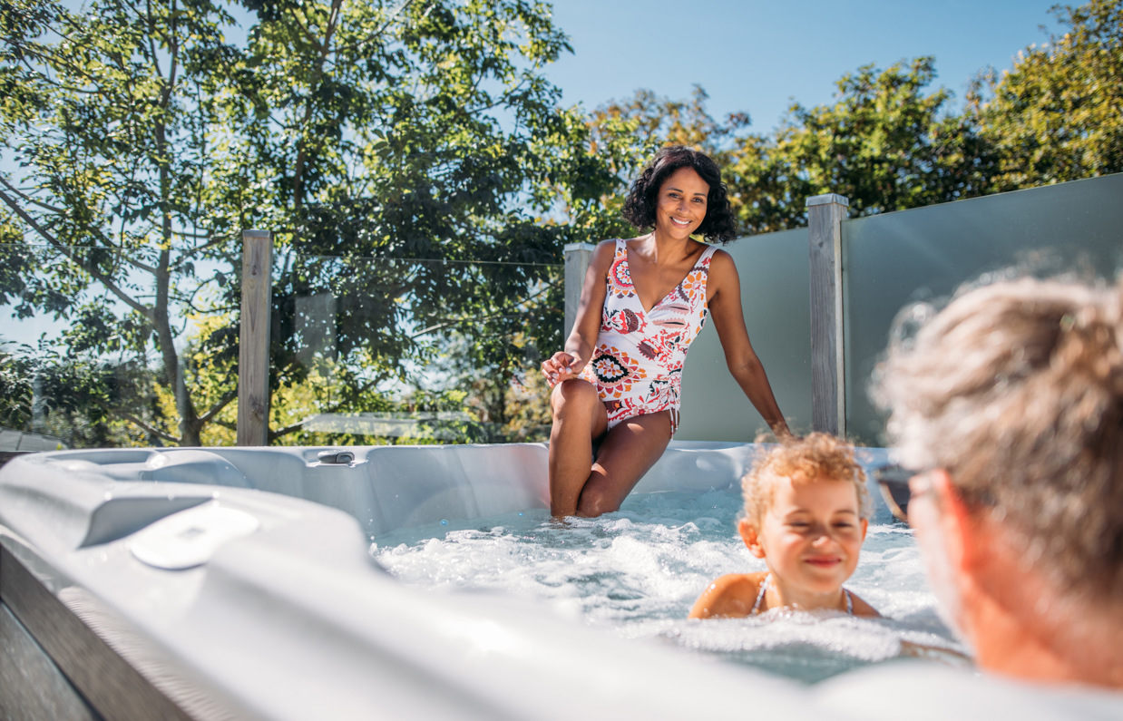 Family in hot tub surrounded by trees