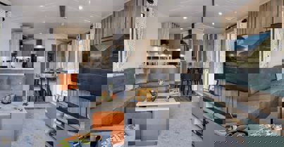 Open-plan lounge, diner and kitchen with large grey L-shape sofa