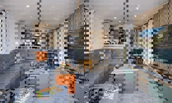 Open-plan lounge, diner and kitchen with large grey L-shape sofa