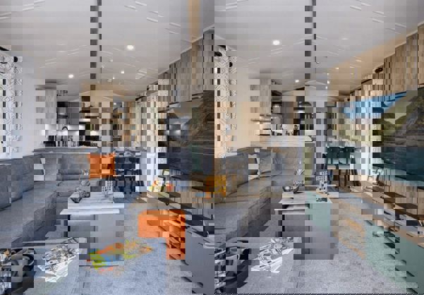 Open-plan lounge, diner and kitchen with large grey L-shape sofa