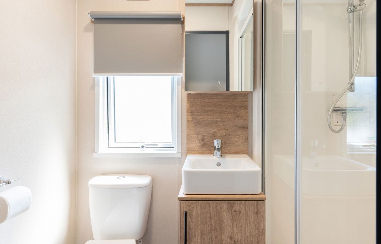 Internal of a caravan bathroom with shower, toilet and sink