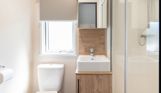 Internal of a caravan bathroom with shower, toilet and sink