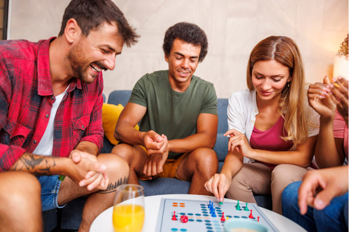 People sat around a small table playing a board game