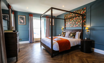 Internal of a manor house master bedroom with four poster bed 