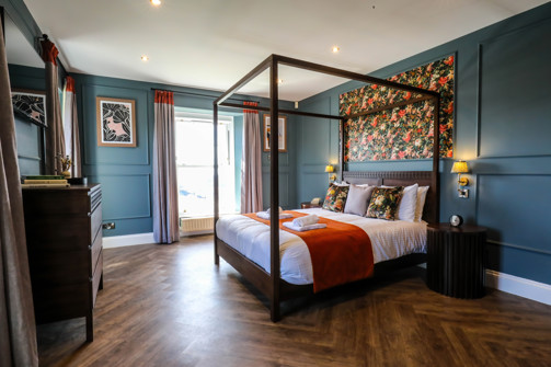Internal of a manor house master bedroom with four poster bed 
