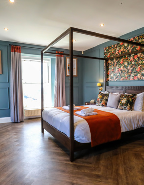 Internal of a manor house master bedroom with four poster bed 