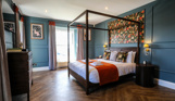 Internal of a manor house master bedroom with four poster bed 