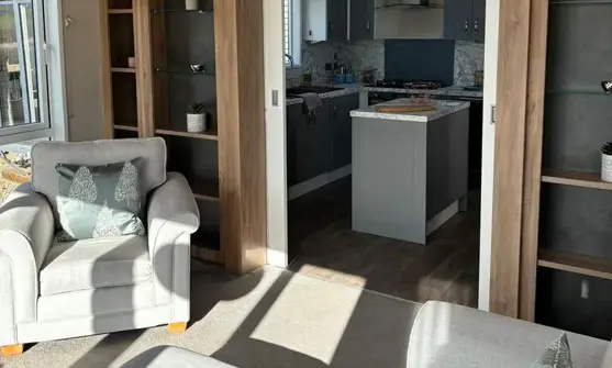 Lounge view through to kitchen separated by shelving and sliding doors