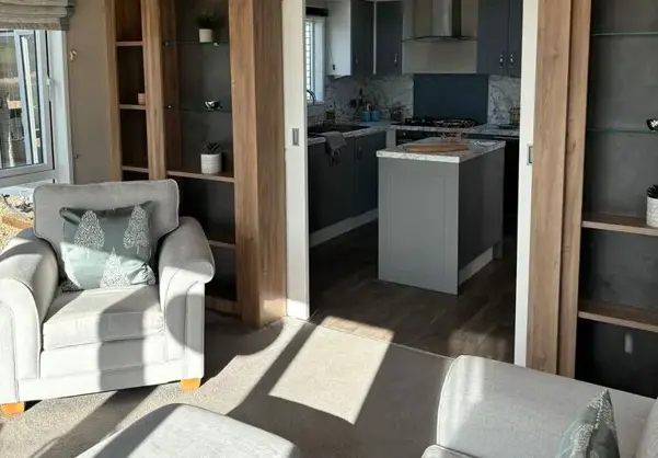 Lounge view through to kitchen separated by shelving and sliding doors