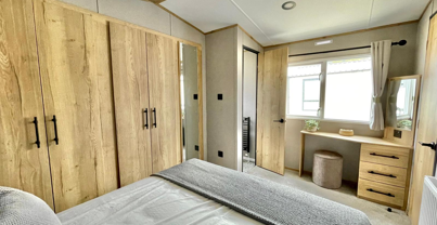 Internal of a caravan master bedroom with dressing area