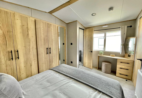 Internal of a caravan master bedroom with dressing area