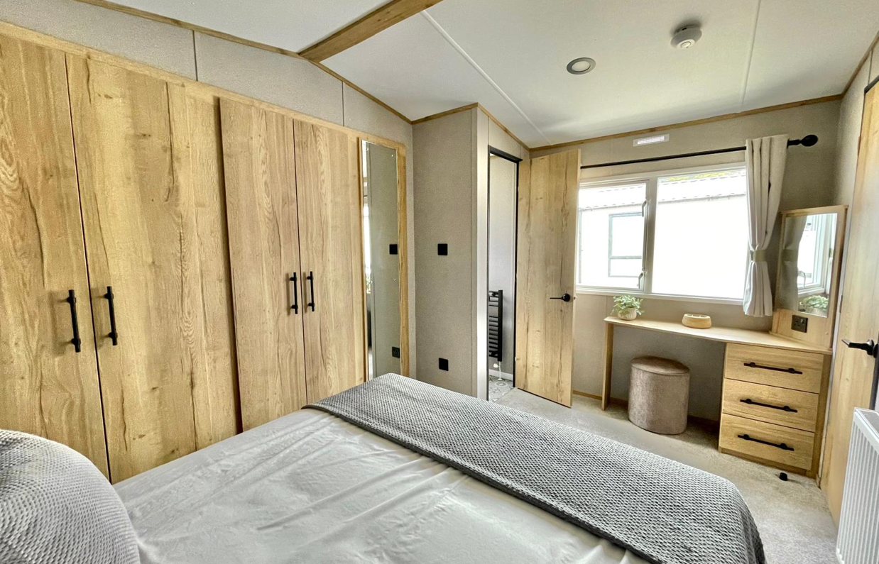 Internal of a caravan master bedroom with dressing area