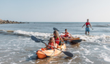 A family of four kayaking in the sea