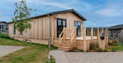 External of a luxury lodge on pitch with decking