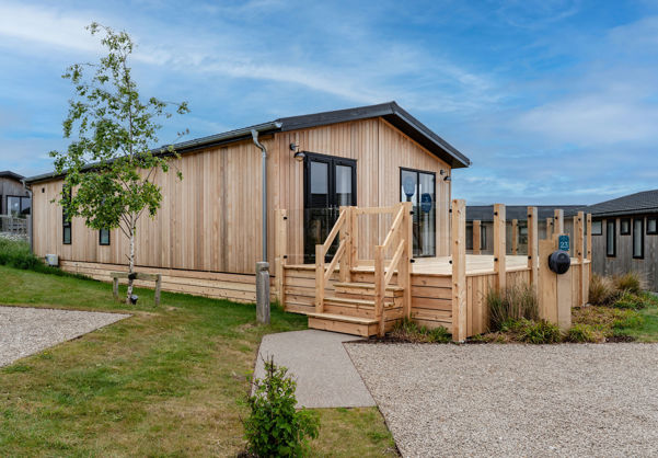 External of a luxury lodge on pitch with decking