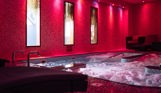 A hydrotherapy pool with loungers and calm lights