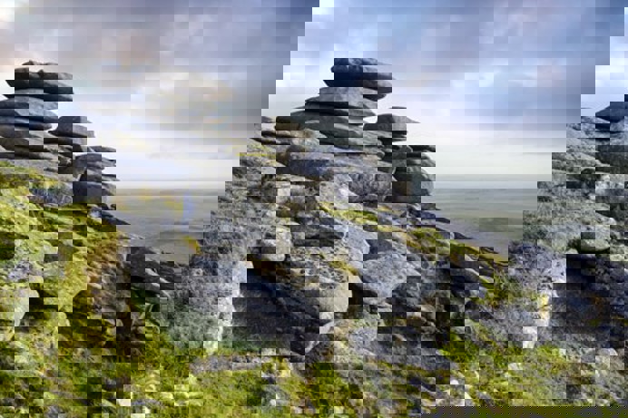 A rocky mountain side with far stretching views