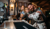 A family of four at the bar in Stargazy Bar & Grill with a dalmatian