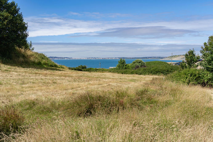 View of sea from countryside around Osmington Mills Lodge Park