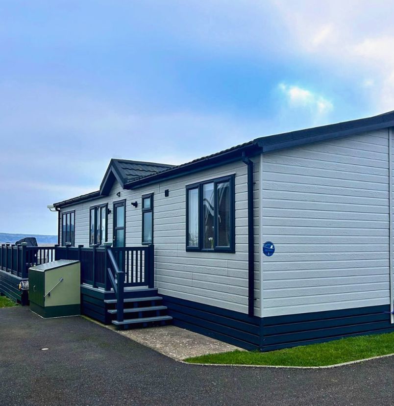 External of a caravan on pitch with decking and seaviews 