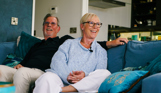 Stables Owners laughing on sofa