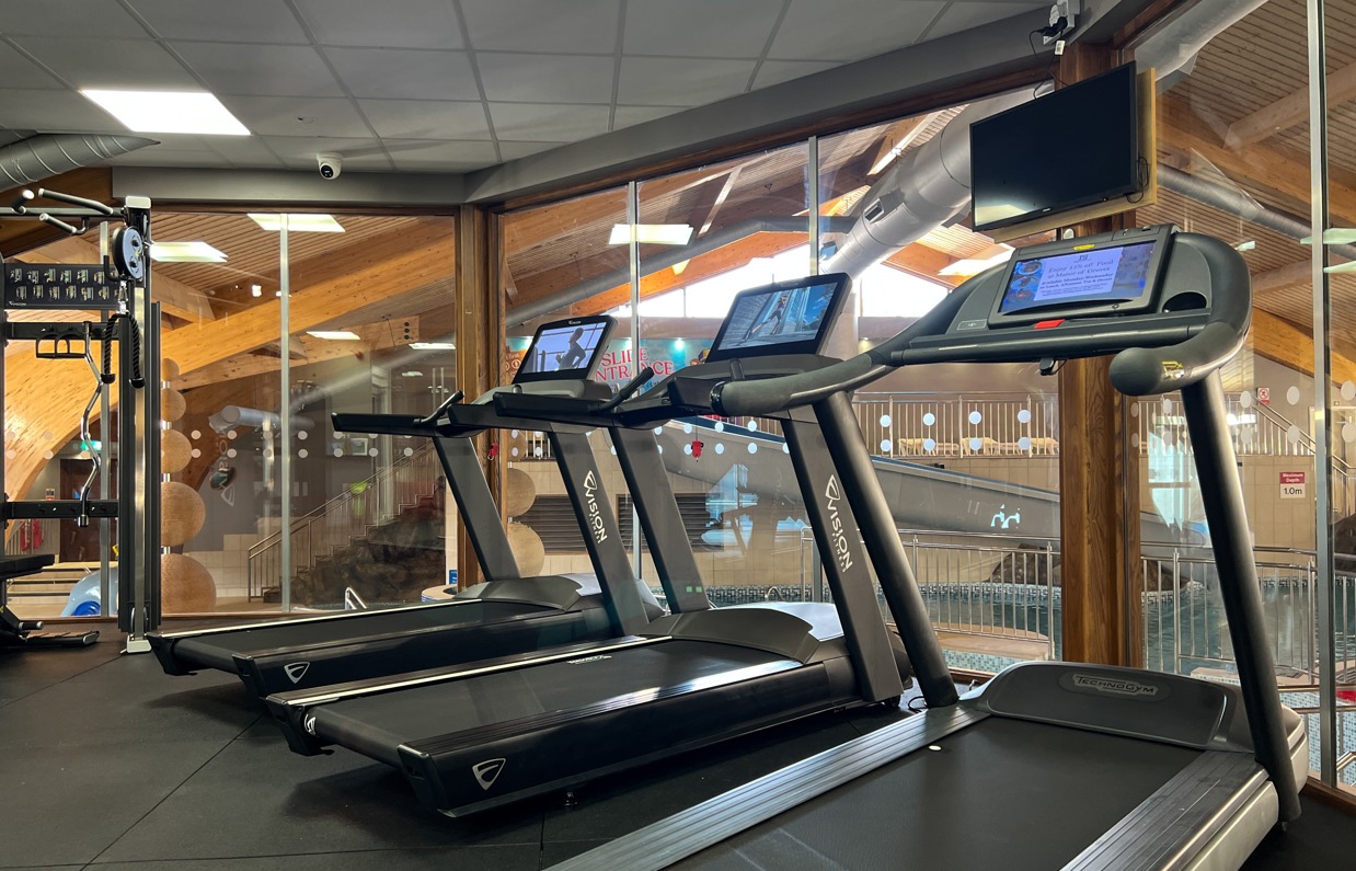 Inside of a modern gym facility with various equipment