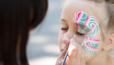 A young girl having her face painted