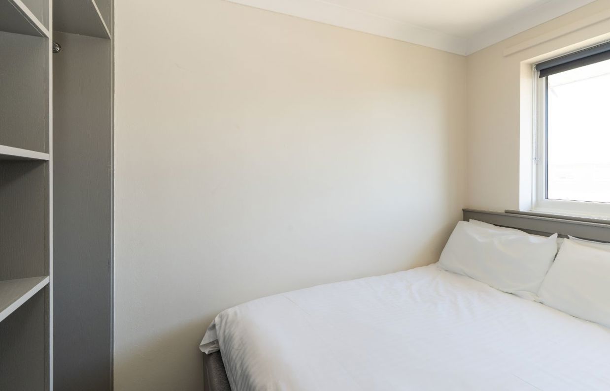 Internal of a Chesil Beach apartment double bedroom with storage