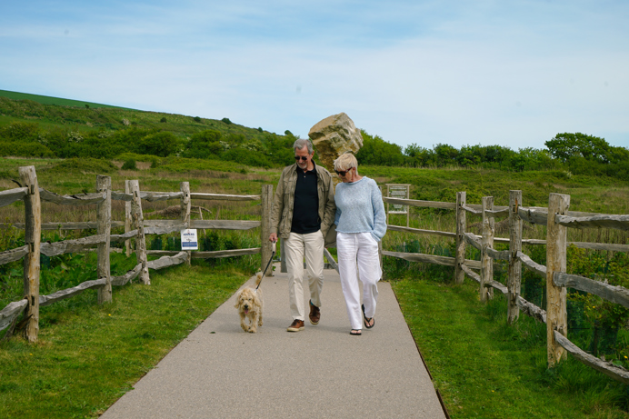Stables Owners walking dog on development