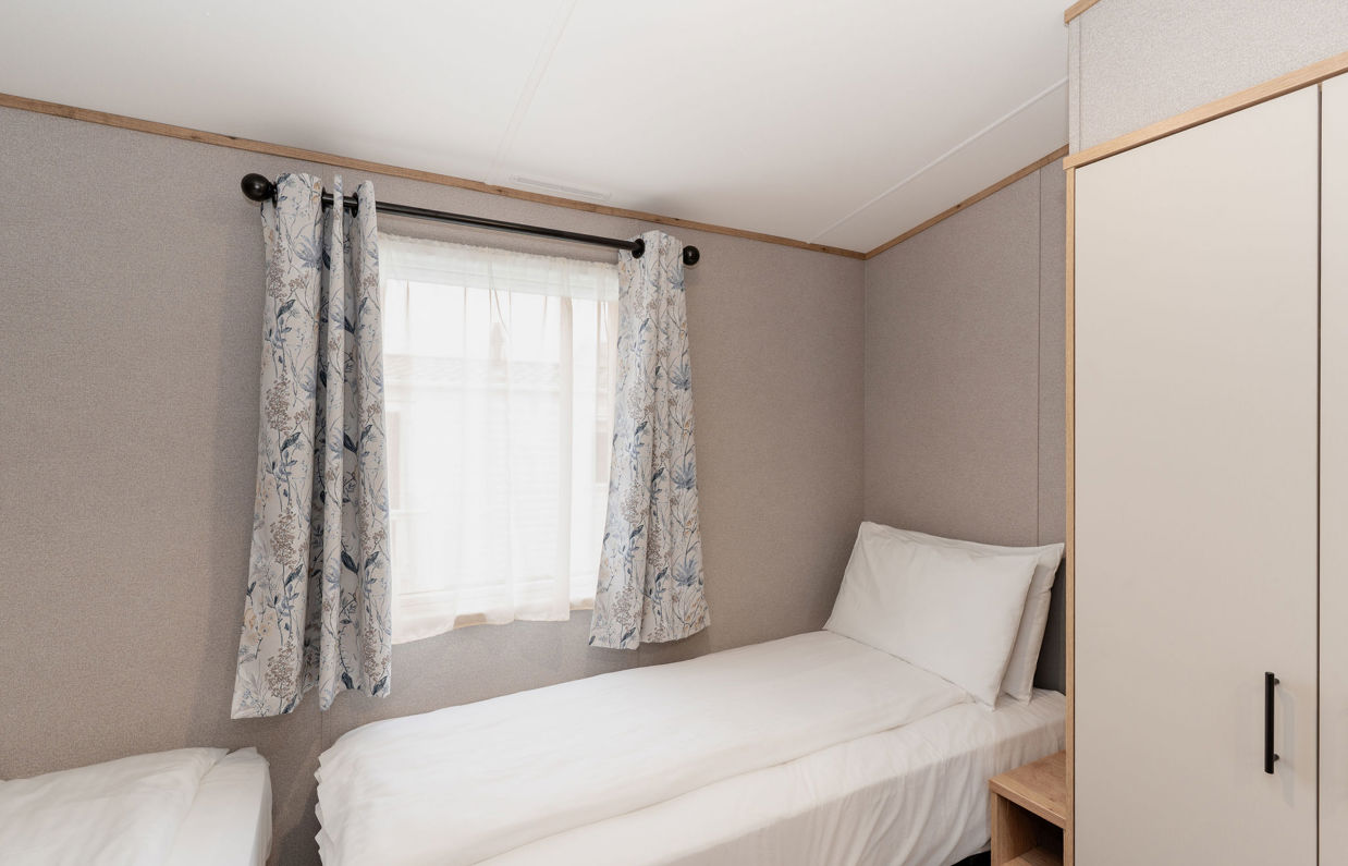 Internal of an accessible caravan spacious twin bedroom