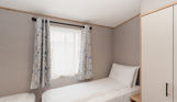 Internal of an accessible caravan spacious twin bedroom