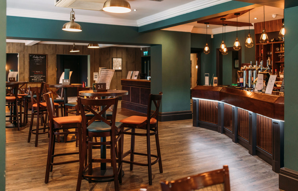 Internal of the country club restaurant and bar with a cosy moody atmosphere and plenty of chairs and tables