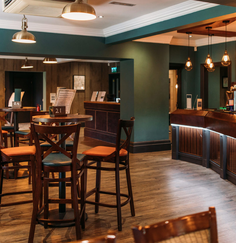 Internal of the country club restaurant and bar with a cosy moody atmosphere and plenty of chairs and tables