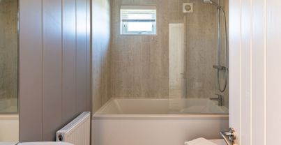Internal of a cabin bathroom with shower over bath