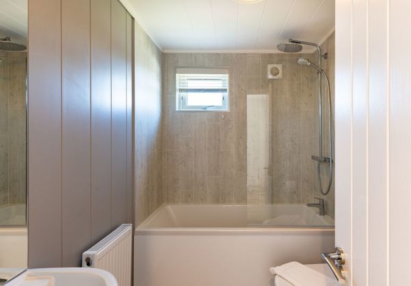 Internal of a cabin bathroom with shower over bath