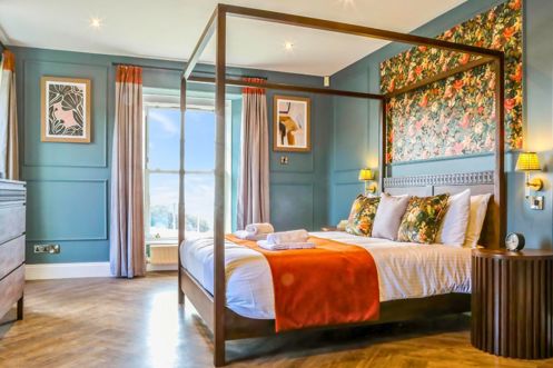 Internal of a manor house master bedroom with four poster bed 